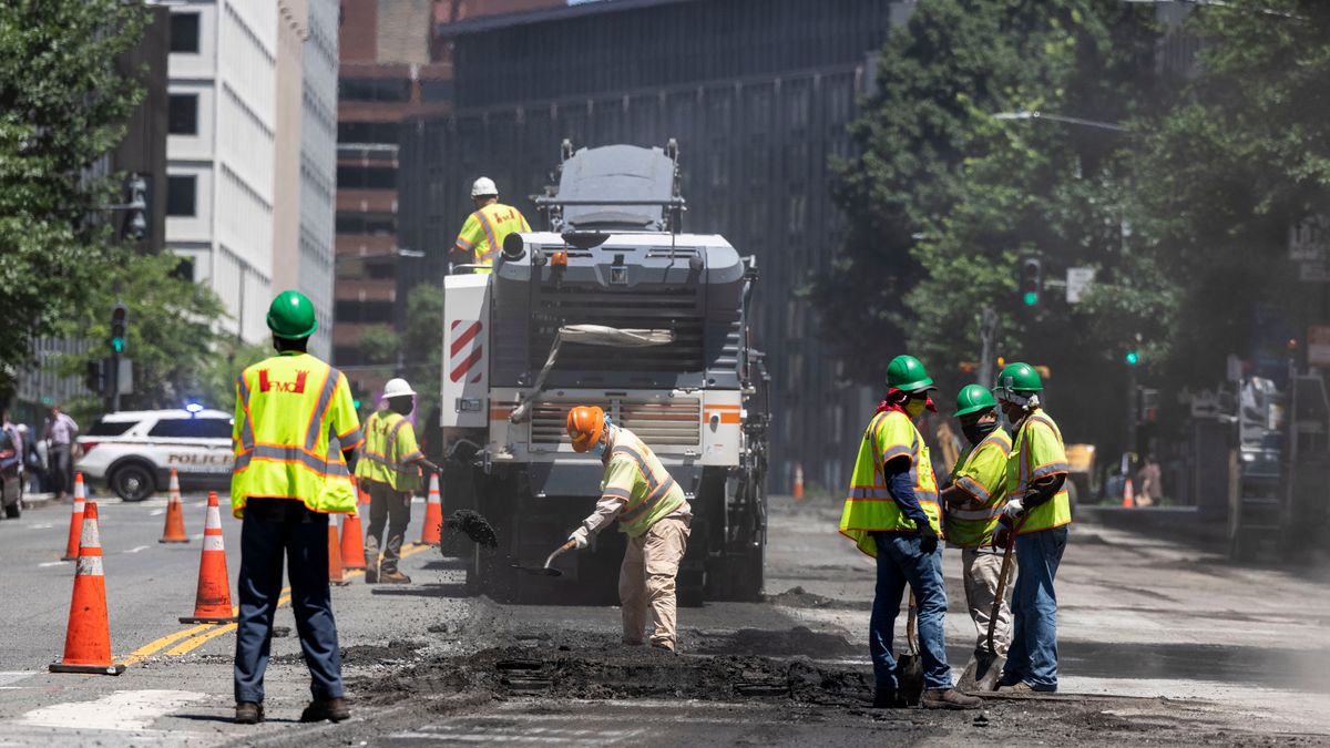 Construction workers repave 17th Street NW on June 23, 2021 in Washington, DC.